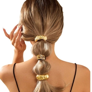Golden irregular textured metal hair cuffs with hammered and ribbed patterns for ponytails