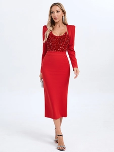 Detail of red sequins and smooth fabric stitching on an elegant long-sleeved evening dress