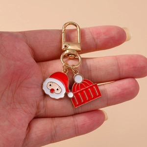 Handheld Christmas keychain with Santa charm, red knitted hat, and golden alloy finish