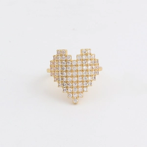 Macro detail of pixel heart ring with pave-set crystals on gold-plated band
