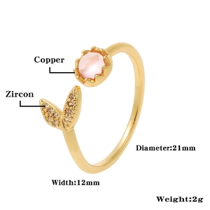 Detailed view of golden crown ring showing pink stone, zircons, and product dimensions