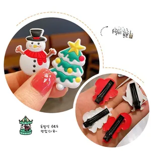 Detail of Christmas hair clips featuring snowman and tree shapes on metal duckbill clips