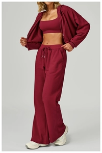 Close-up of three-piece burgundy tracksuit with hoodie and drawstring wide-leg pants