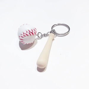 Detailed close-up of a mini wooden baseball bat and white stitched ball on a silver keychain
