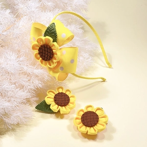 Detail view of sunflower hair clip and polka dot yellow bow headband for girls