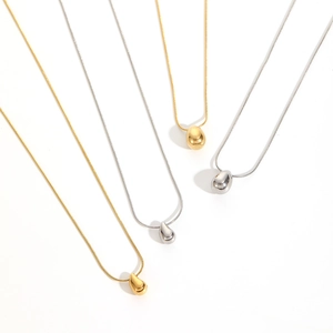 Detail of 18k stainless steel water drop pendants in gold and silver finishes