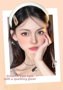 Macro view of amber textured hair clip and white plush headband on model side profile