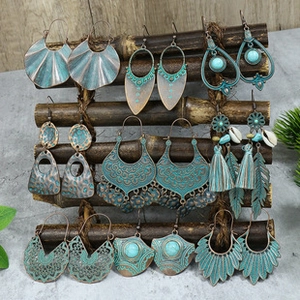Detail view of 9 pairs Bohemian vintage earrings set with turquoise and tassel accents