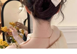 Elegante goldene Schlangenkette an einem Modelhals in einer warmen Innenspiegel-Szene