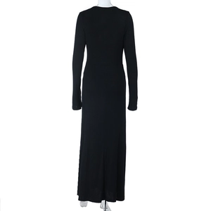 Back view of a long black slim fit dress on a mannequin with round neck and long sleeves