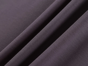 Close-up of deep purple slim-fit yoga shirt fabric with fine knitted texture