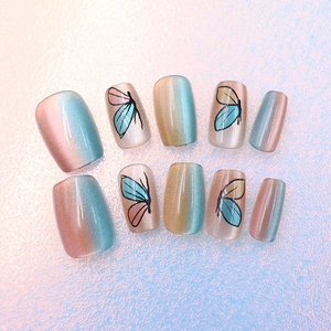 Macro view of Aurora cat eye press-on nails with blue butterfly wing gradient design