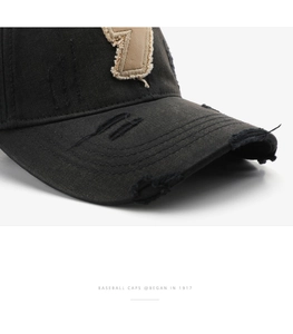 Detailed macro view of distressed cotton baseball cap with number 7 patch and frayed edges