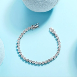 Sparkling S925 silver flower-shaped tennis bracelet with zircon stones on a soft blue base