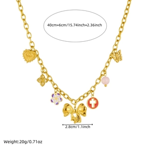 Gold multi-charm necklace with bow, flower, and cross pendants on white background