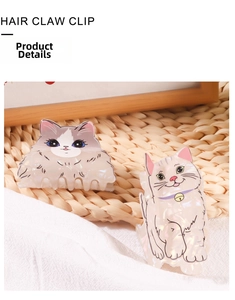 Detail of cute cat hair claw clips made of pearlescent acetate on a rustic woven mat