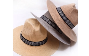 Detailed view of woven straw sun hats with geometric patterned bands in various colors
