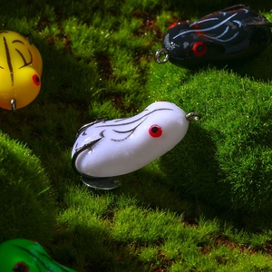Macro shot of colorful soft fishing frog lures on moss for snakehead fishing