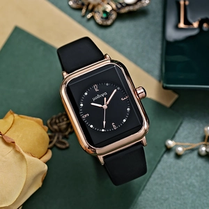 Detail of rose gold rectangular quartz watch with black matte strap and dried roses