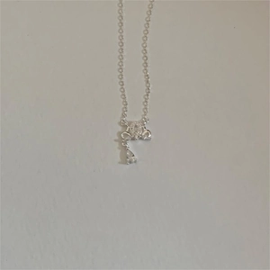 Close-up of a 925 silver necklace featuring a crown pendant with a teardrop zircon charm