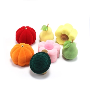 Assorted velvet jewelry boxes in pumpkin, pear, flower, and turtle shapes