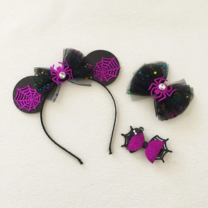 Halloween headband set with purple spider web ears and glittery bow clips on white background