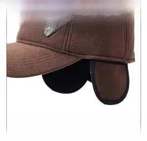 Detail of winter baseball cap with ear flaps featuring thick wool fabric and metal logo