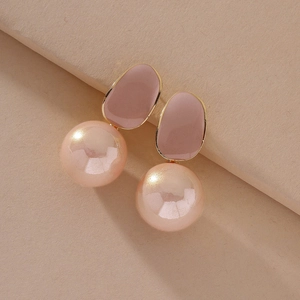 Macro shot of elegant pink pearl drop earrings with purple glaze and gold metallic frame