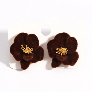 Close-up of geometric flower tassel earrings with dark red velvet texture on white card