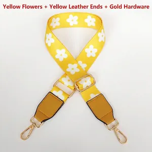 Detail of yellow floral wide shoulder strap with gold metal hooks and adjustable buckle