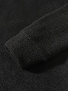 Macro detail of elastic cuffs on black coral fleece pullover jacket for men