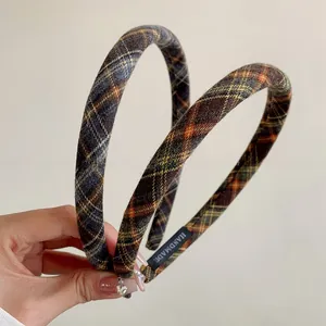 Detail of handmade plaid headbands with woven texture and handmade interior labels
