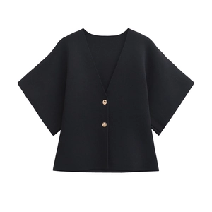 Detail view of black V-neck knitted cardigan with two decorative gold metal buttons