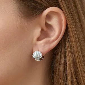 Romantic S925 silver shell earrings with blue enamel and gold starfish worn by model