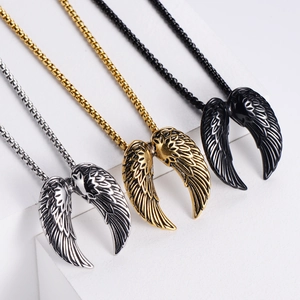 Detailed view of punk angel wing pendants in silver, gold and black with steel chains