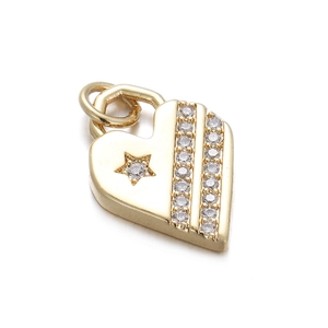 Macro shot of a golden heart pendant with embedded zircons on a white background