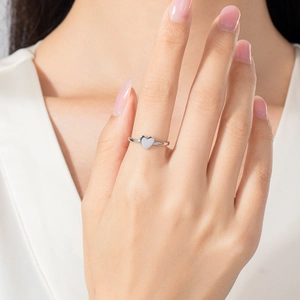 Minimalist S925 sterling silver heart ring worn on hand with a clean white background