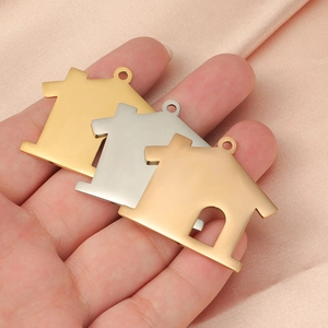 Set of three house-shaped stainless steel charms in gold, silver, and rose gold finishes