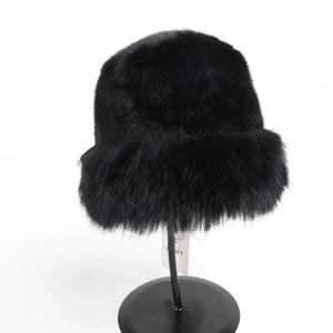 Close-up of thick black faux fur bucket hat showing plush texture and glossy finish