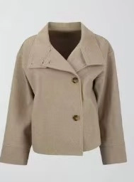 Vue détaillée de la veste courte en laine beige avec de gros boutons marron foncé