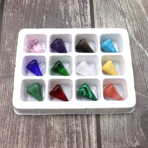 Set of 12 mixed natural stone hexagonal pointed pendants in a white plastic storage tray