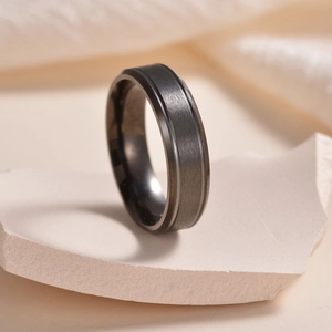 Dettaglio dell'anello in acciaio inossidabile nero spazzolato opaco con bordi lucidi