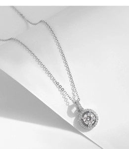 Detail of 1ct Moissanite sterling silver pendant necklace with halo of small stones