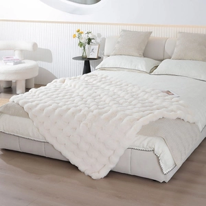 Detailed close-up of white bubble texture on ultra-soft faux rabbit fur blanket