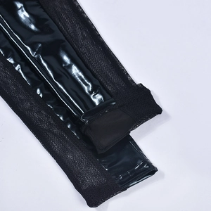 Detail of black faux leather and mesh patchwork texture on high-waisted leggings