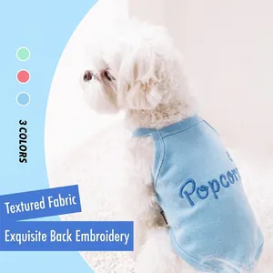 Detailed close-up of blue cotton popcorn embroidered pet vest in three colors