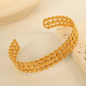 Minimalist open gold bangle for women featuring a triple-row textured circular disk design