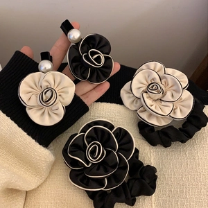 French style camellia hair clip and scrunchie set with pearls on tweed fabric background