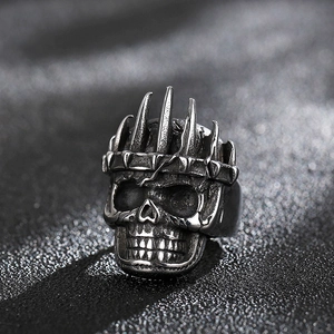 Close-up of gothic skull ring with spiked crown detail and vintage silver finish