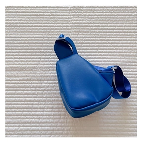 Detail view of the blue faux leather kids' chest bag with adjustable nylon shoulder strap